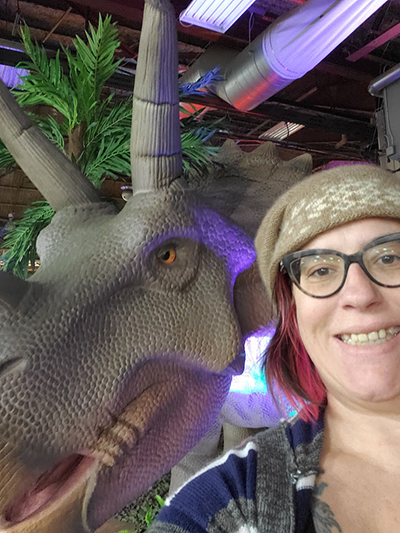 Animatronic triceratops and Molly Prower who wears glasses and is wearing a muskox hat.